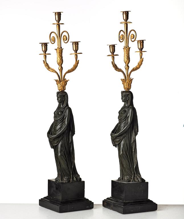 A pair of French Empire early 19th century three-light candelabra.