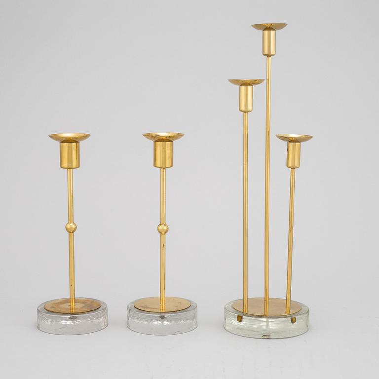 Gunnar Ander, a set of three brass and glass candlesticks from Ystad Metall.