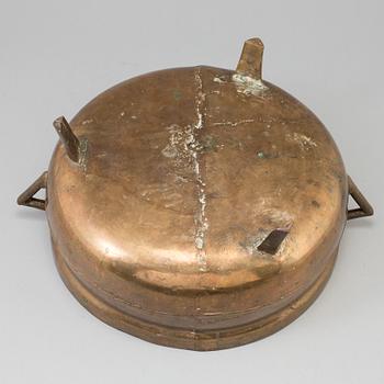 A 19th century brass cauldron.