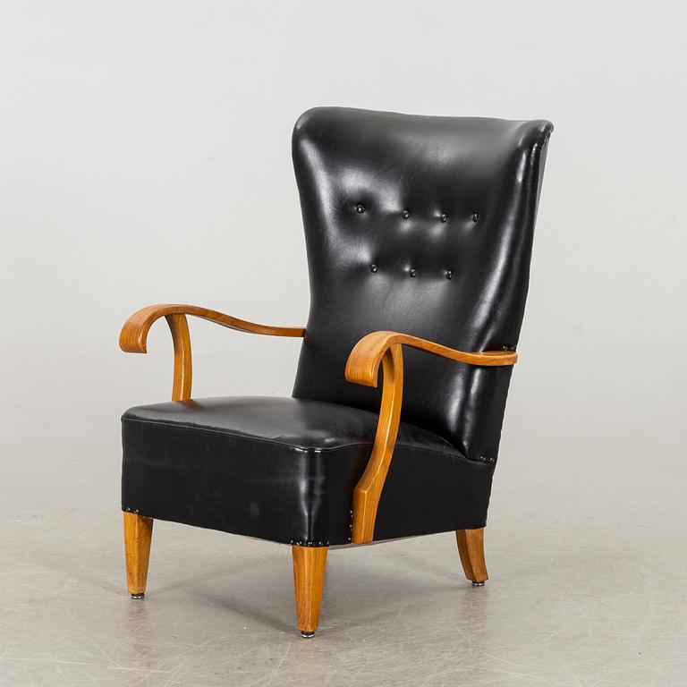 A 1940's - 50's easy chair in black leather, Scandinavian.