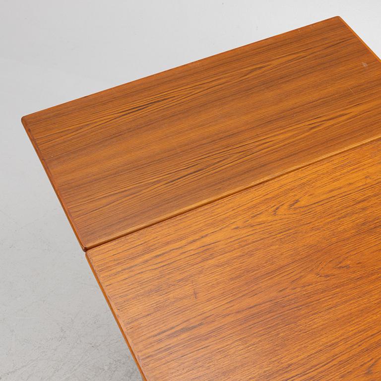 A dining table with four chairs, mid 20th century.