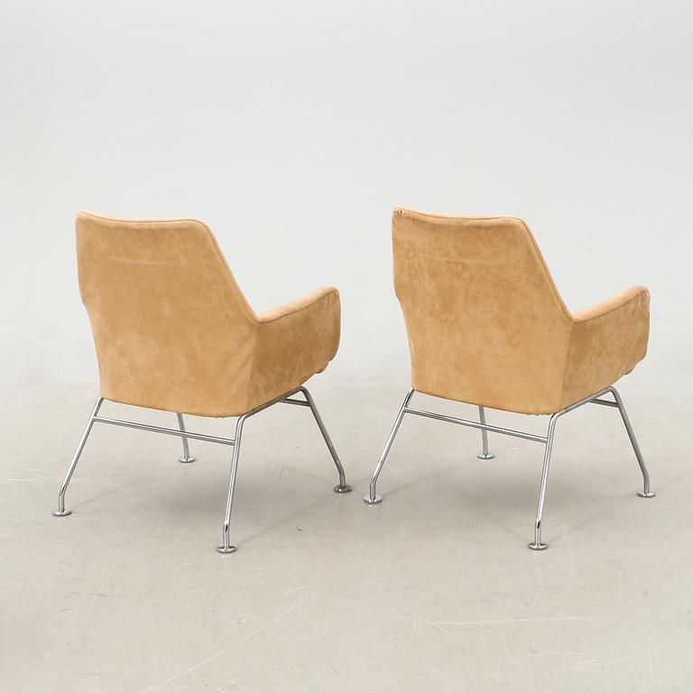 Bruno Mathsson, a pair of "Mirja" armchairs for DUX, late 20th century, and a table.