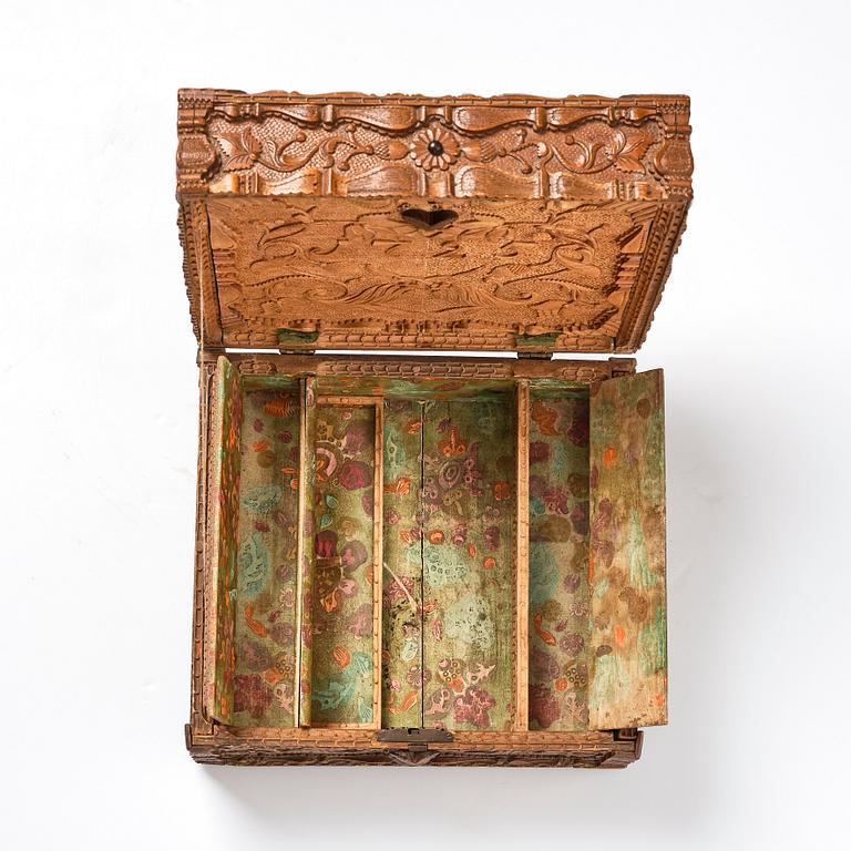 A baroque wedding casket, carved wood, dated 1725.