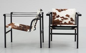 A pair of Le Corbusier 'LC-1' black lacuered steel and cow hide armchairs, Cassina, Italy.