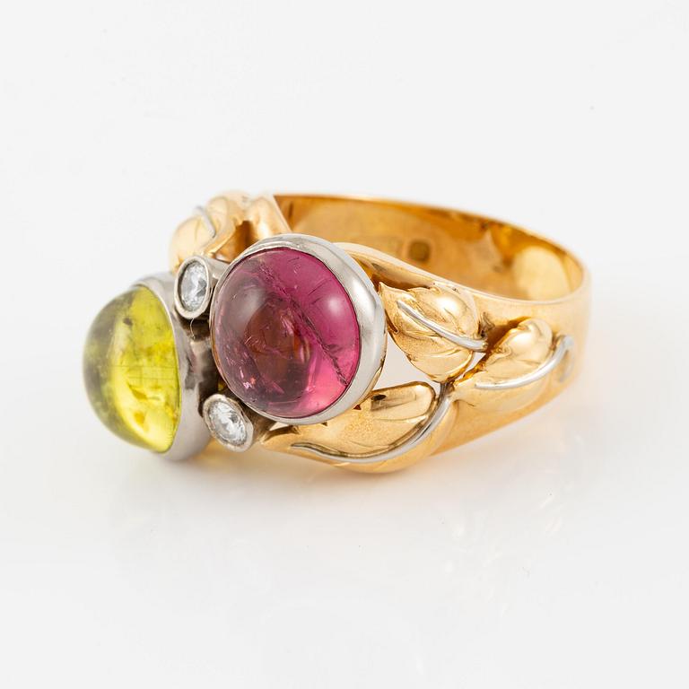 An 18K gold ring with cabochon-cut tourmalines.