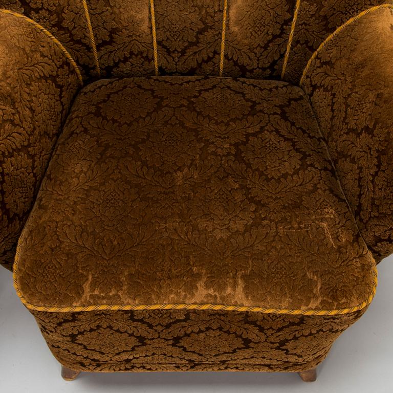 A pair of mid-20th-century armchairs.