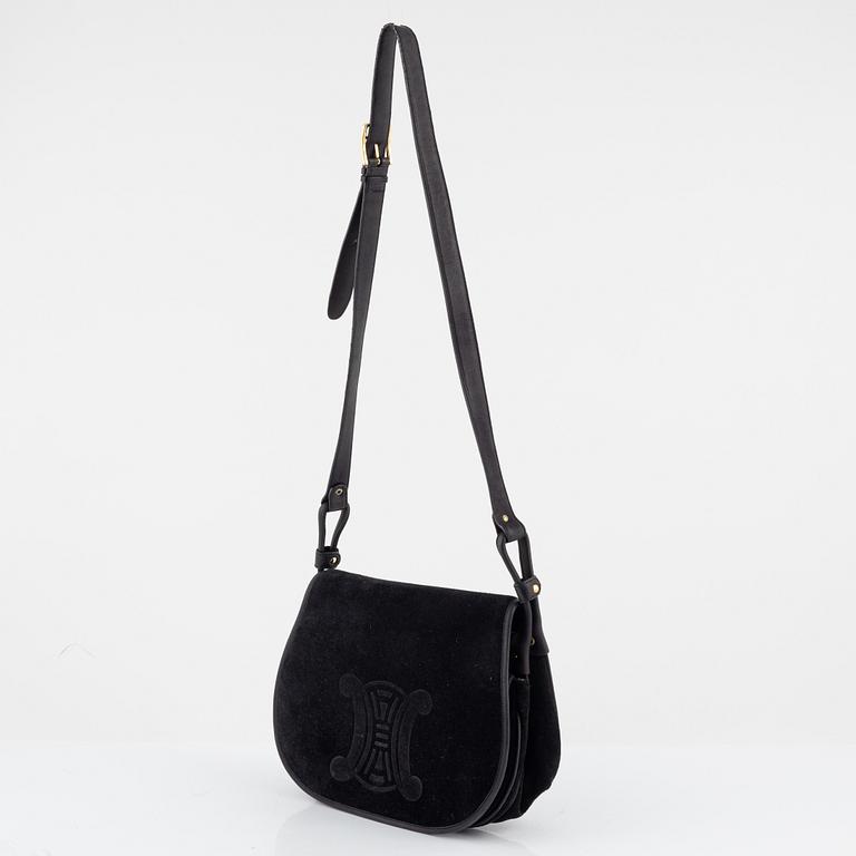 Céline, a black suede handbag.