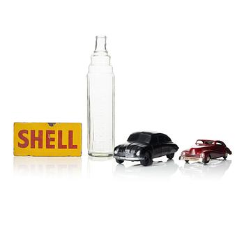 211. Automobile memorabilia, 4 pieces comprising 2 cars, 1 bottle and 1 tin sign.