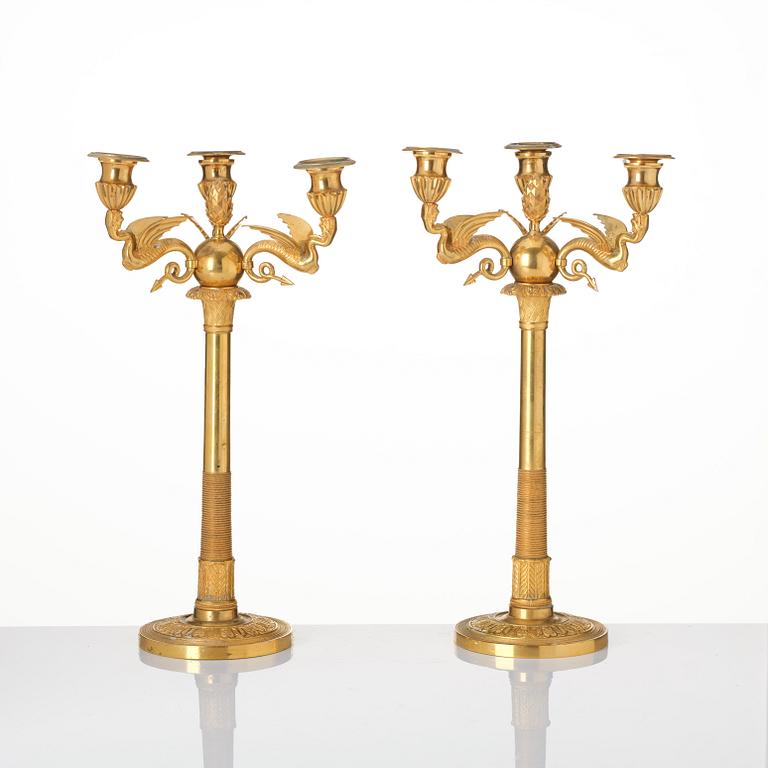 A pair of three-branch Empire-style ormolu candelabra, 19th century.