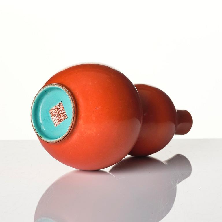 A coral red-enameled double-gourd vase, Qing dynasty with Jiaqing mark (1796-1820).