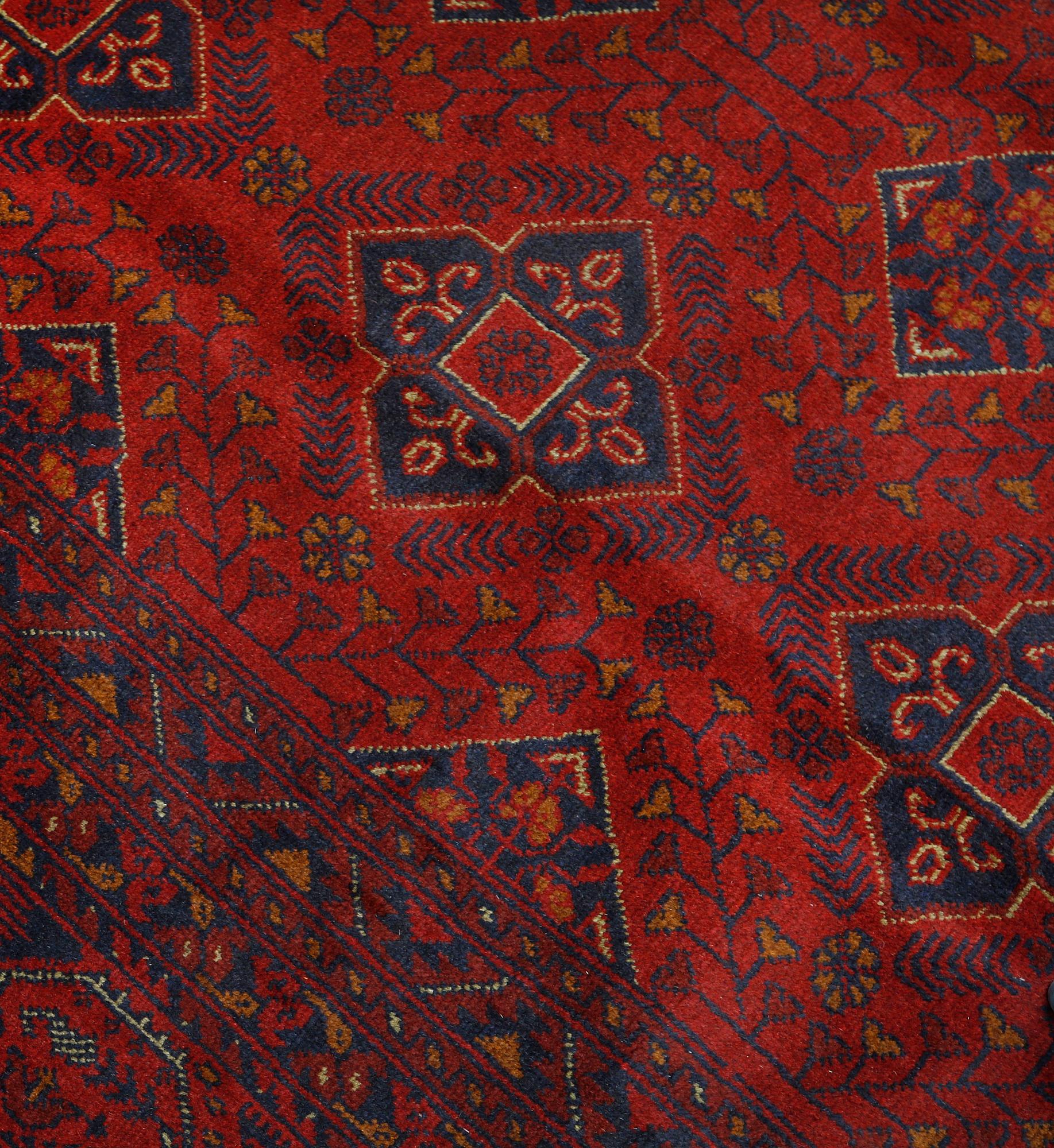 An Afghan carpet, 343 x 243 cm.