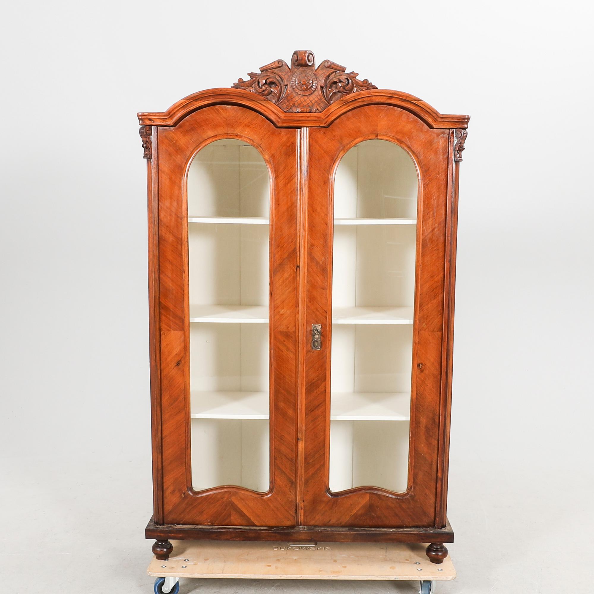 A walnut display cabinet around 1900.