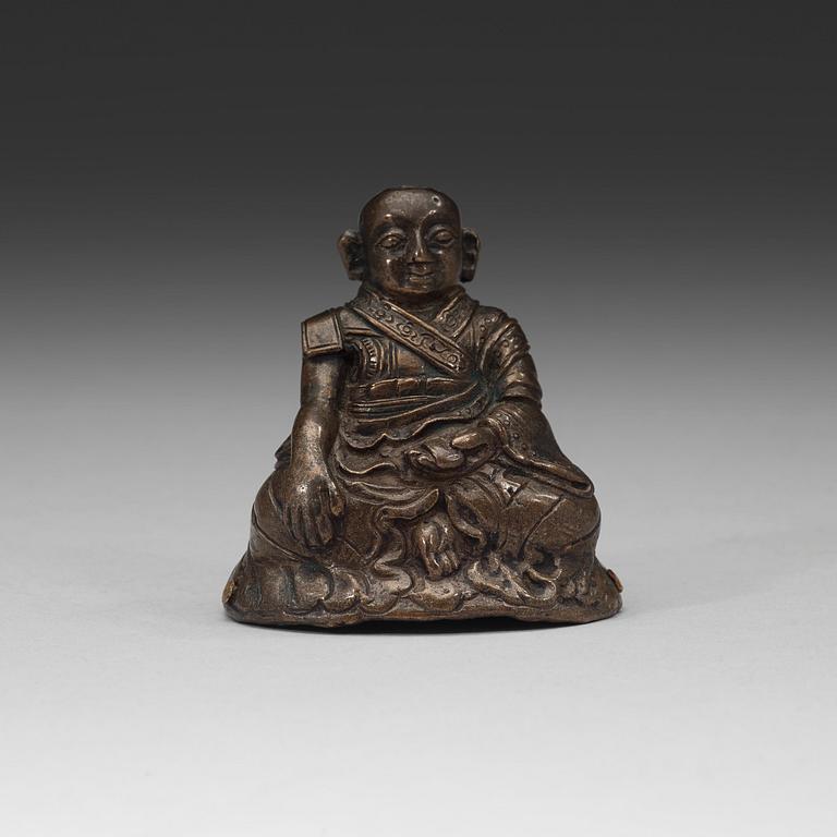 A copper alloy figure of a Lama, Tibet, 18th Century.