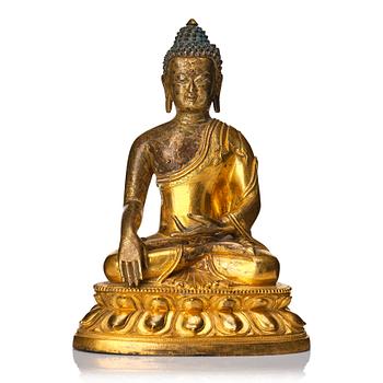 918. A Tibeto Chinese style gilt copper alloy figure of Buddha.