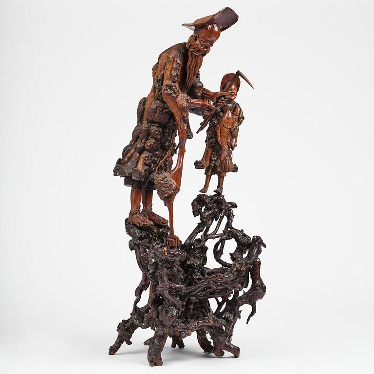 A large well sculptured root sculpture of 'Sholau and attendant', late Qing dynasty, 19th century.