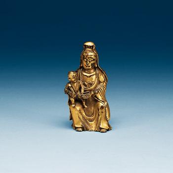 A seated gilt bronze figure of Guanyin with a small boy, Qing dynasty, 18th Century.