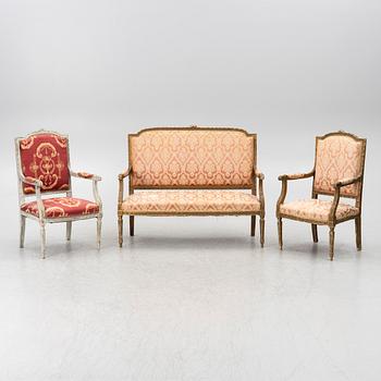 A pair of Louis XVI-style armchairs and a sofa, 20th century.