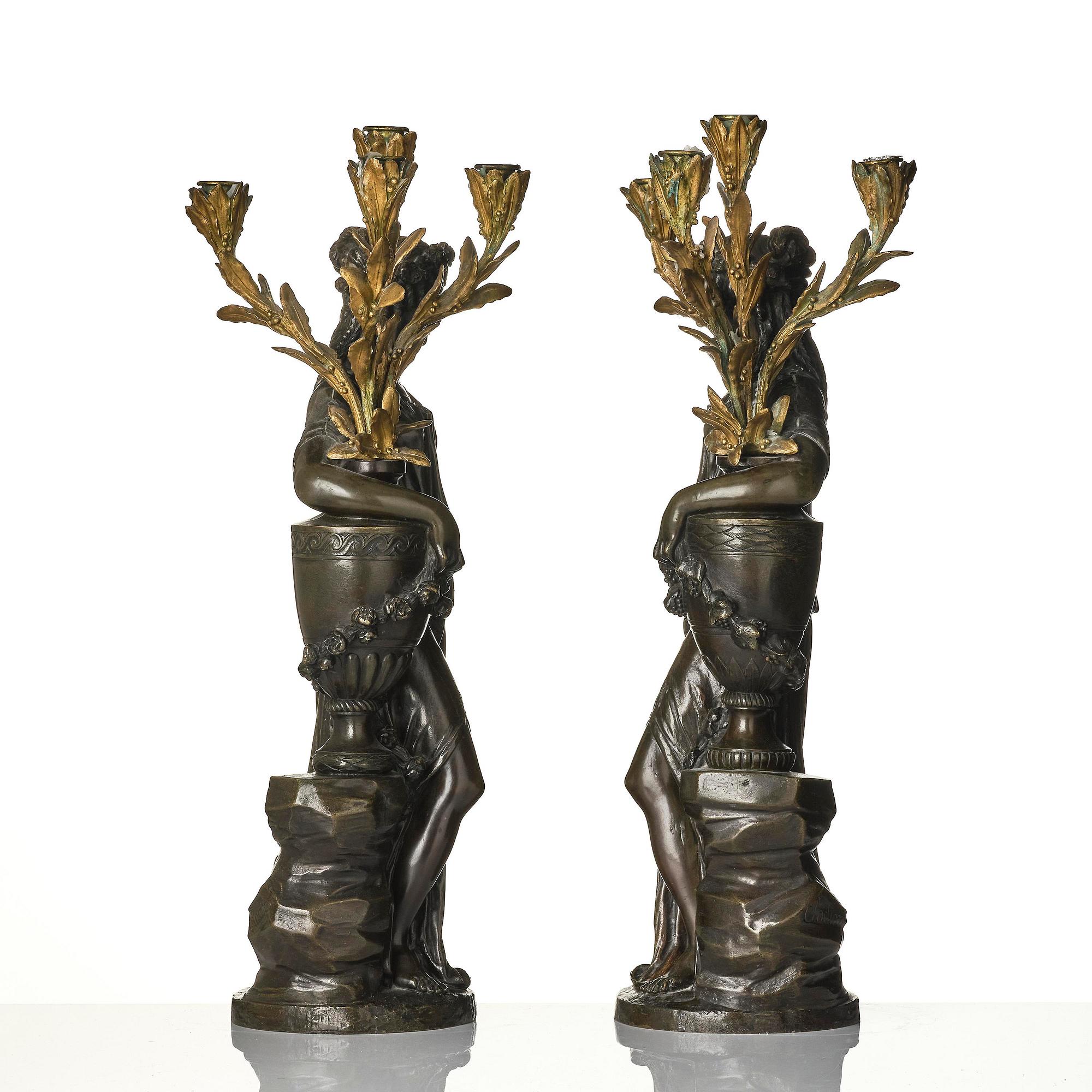 A pair of Louis XVI-style four-light gilt and patinated bronze candelabra after Clodion, later part 18th century.