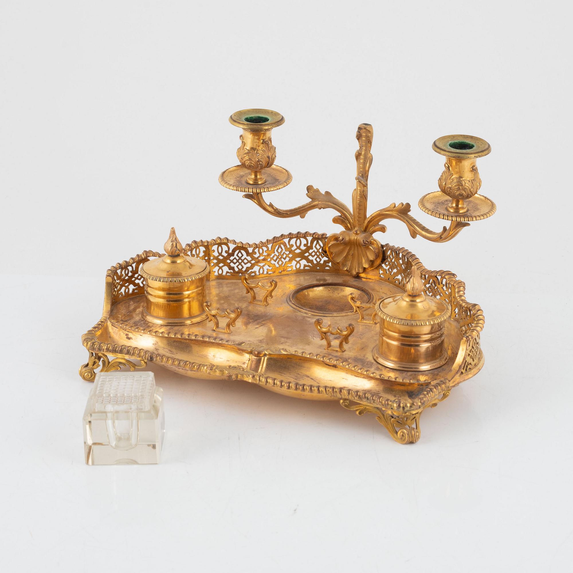 A gilt inkwell and candle holder, around 1900.
