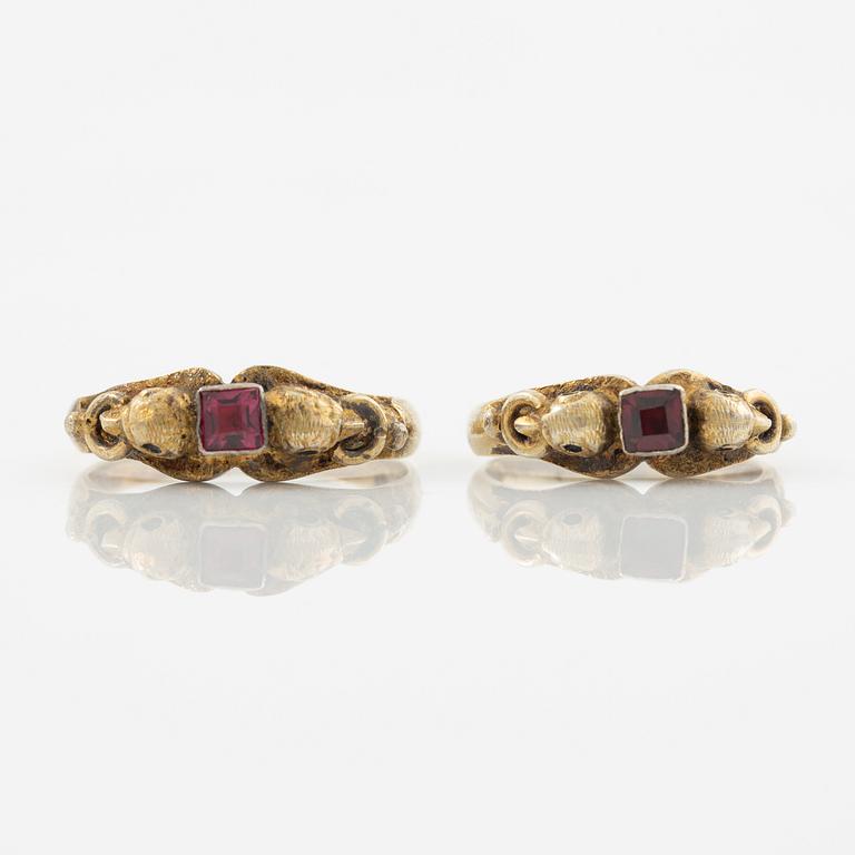 Two rings in silver with pink/red stones.