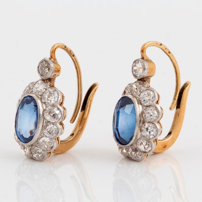 A pair of 14K gold and platinum earings set with faceted synthetic sapphires and old-cut diamonds.