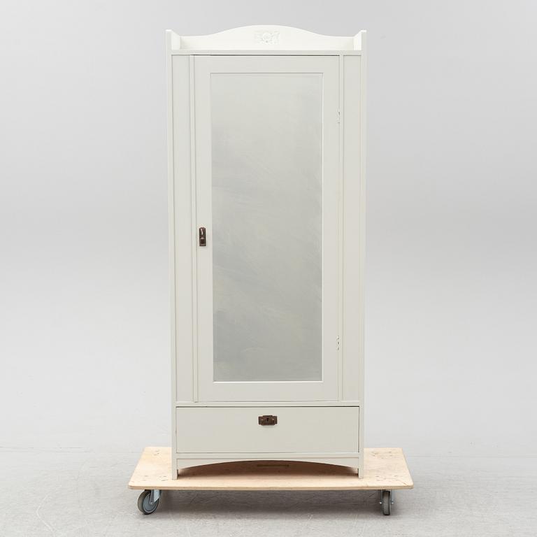 An early 20th Century painted clothes cabinet.