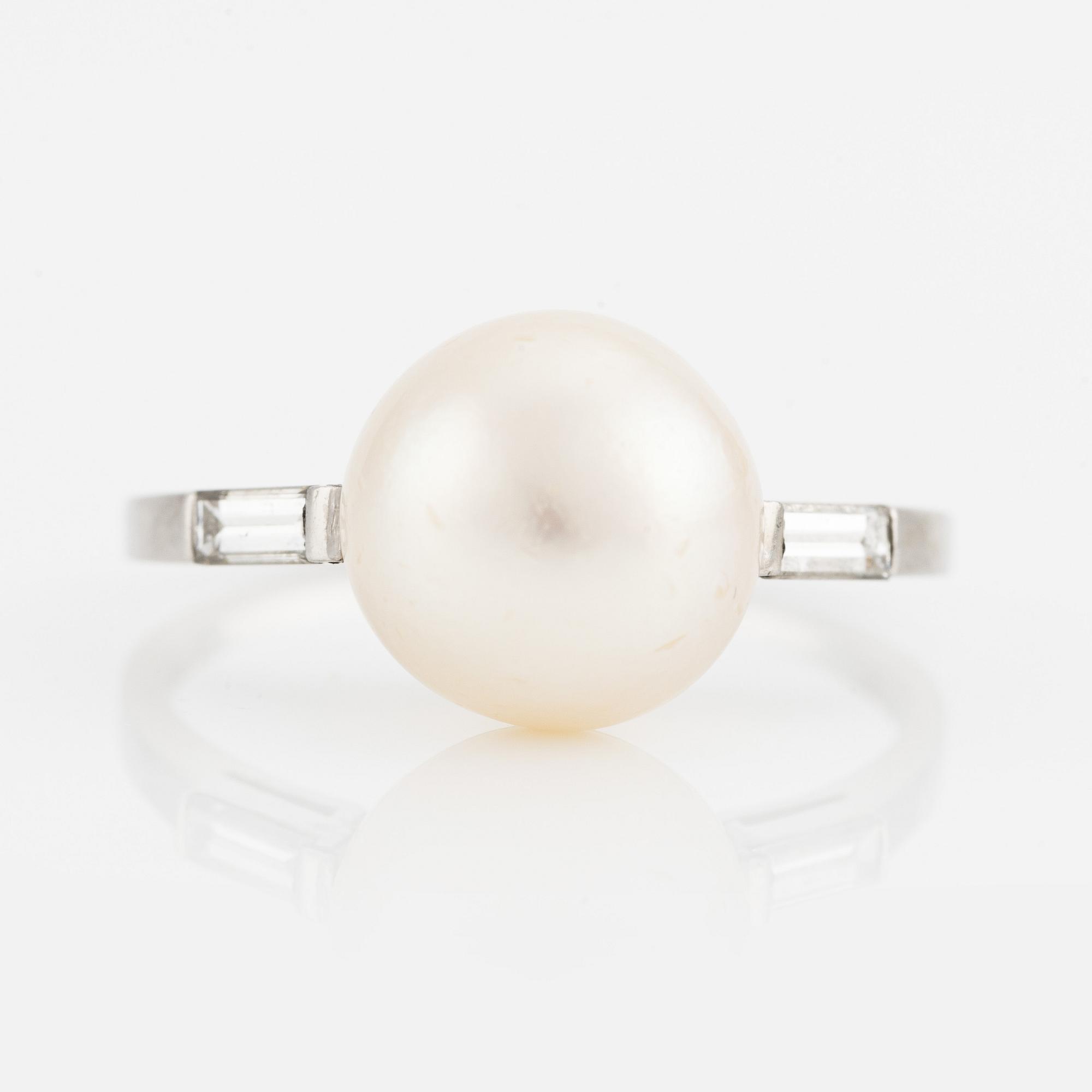 Platinum ring with pearl and baguette-cut diamonds.