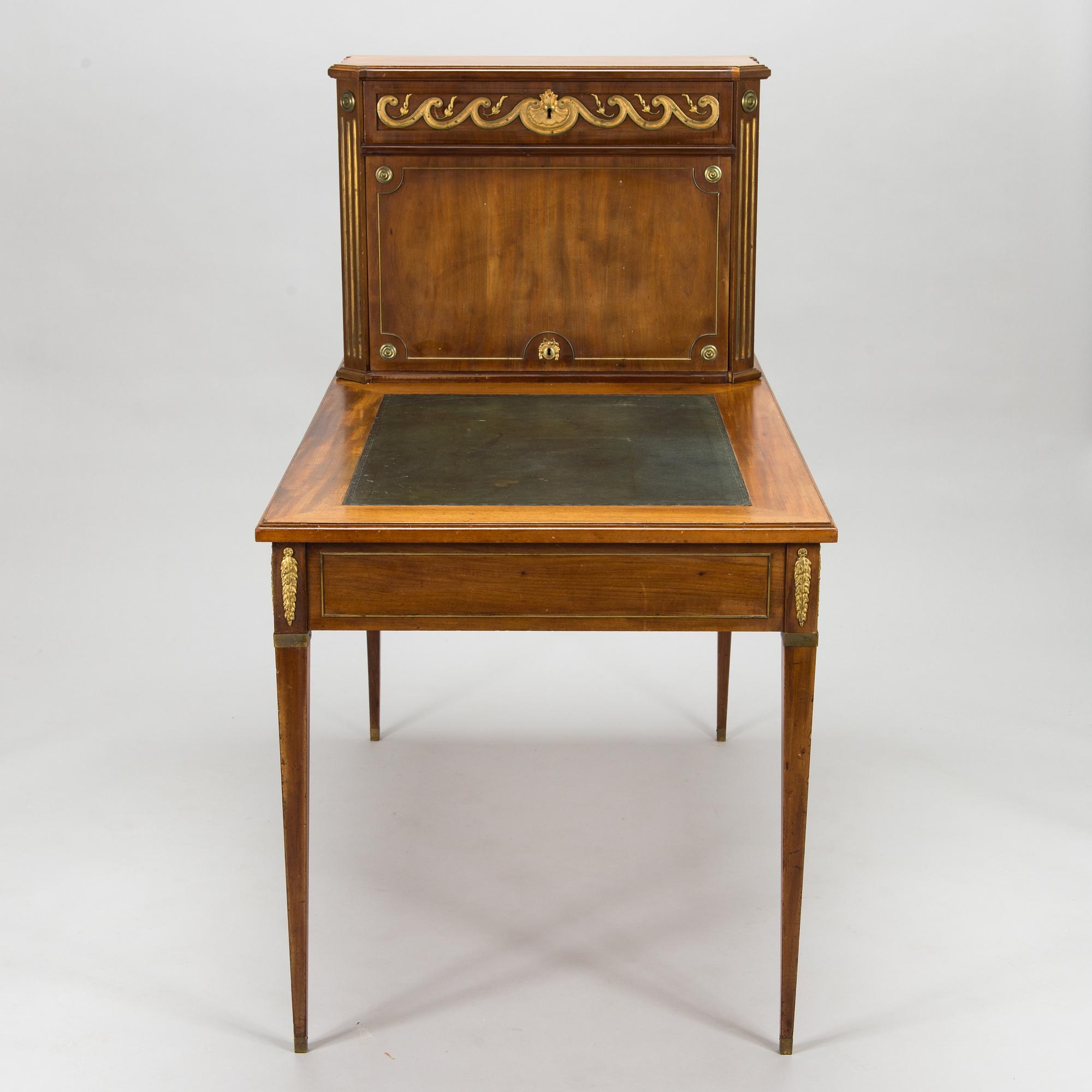 A 20th-century Louis XVI style mahogany veneered writing desk.