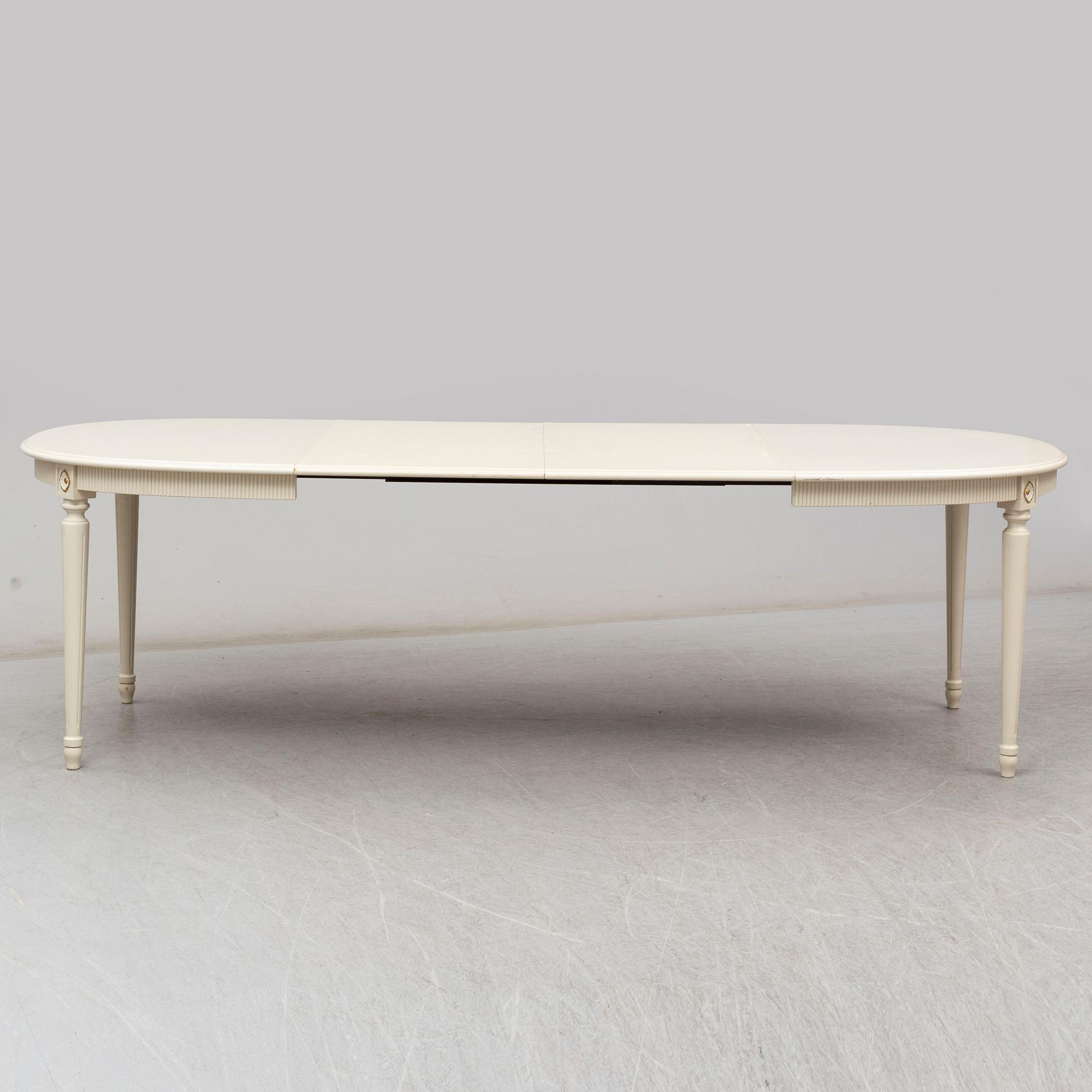 A dining table and 4 chairs, second half of the 20th century. 2 leaves included.