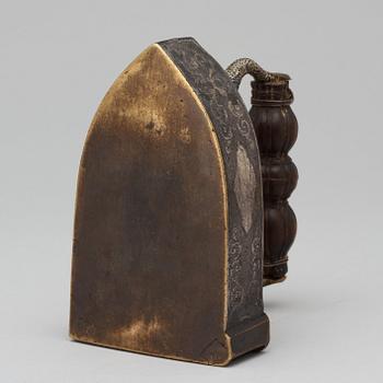 A Baroque 17th century silvered brass flatiron.