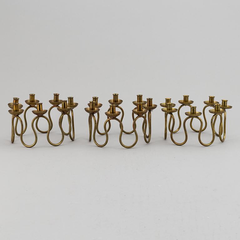 LARS HOLMSTRÖM, Three brass candelabra, Arvika, mid 20th Century.