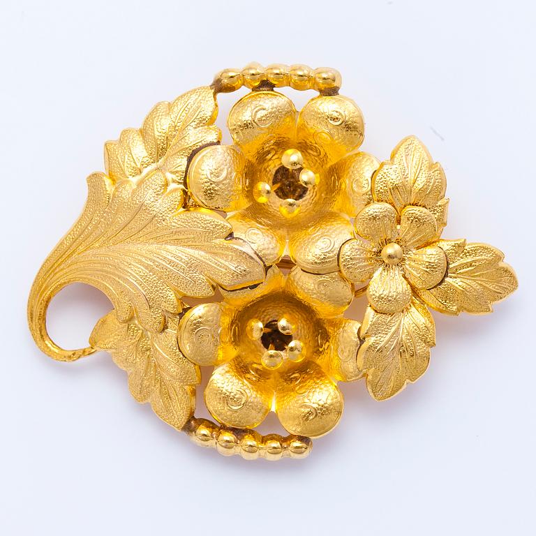 A gold brooch.