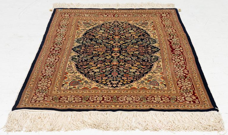 A Hereke silk rug, c. 130 x 71 cm.