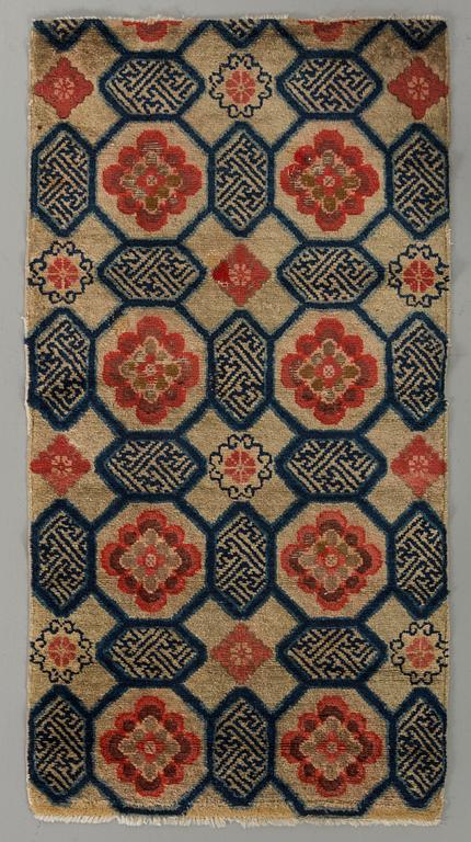 A semiantique Tibetan carpet ca 129 x 67 cm.