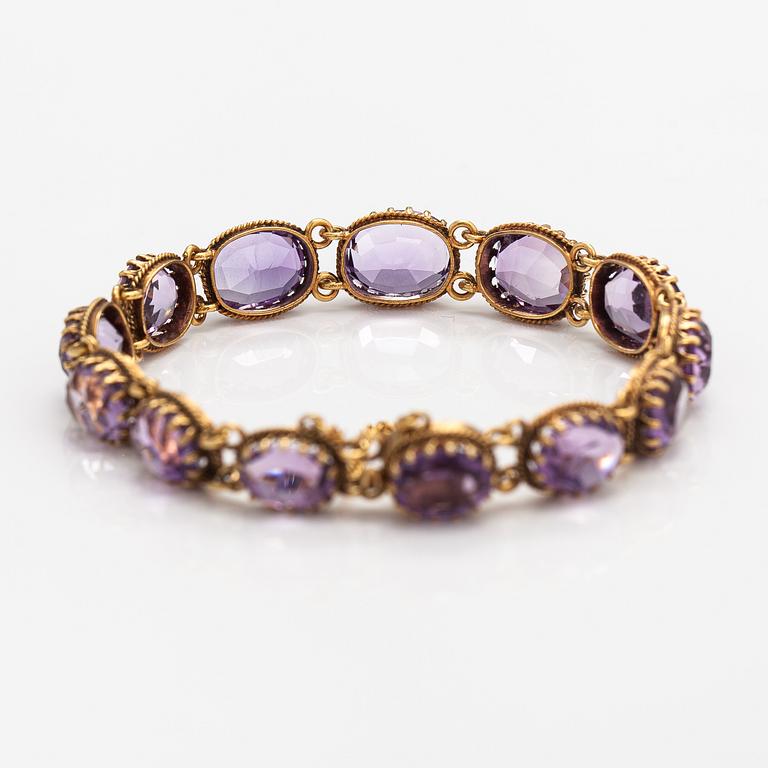 A necklace, bracelet and two brooches in gilded silver and with amethysts and pearls.