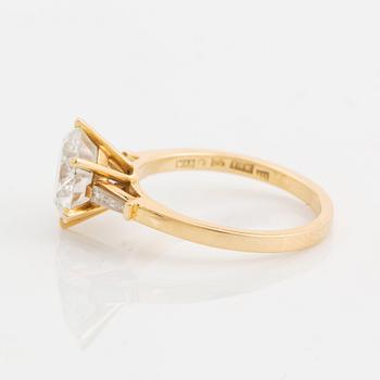 An 18K gold ring set with a round brilliant-cut diamond weight 3.30 cts quality E vs2.