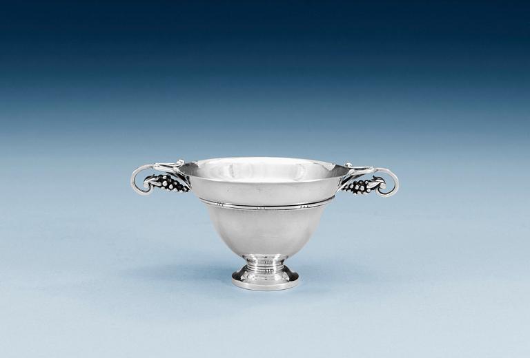 A GEORG JENSEN tea strainer and stand, Copenhagen, the strainer 820/1000 silver, the stand, design nr 251, sterling.