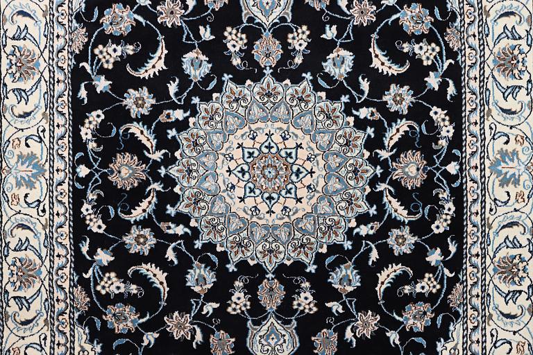 A Nain carpet, part silk, c. 286 x 206 cm.