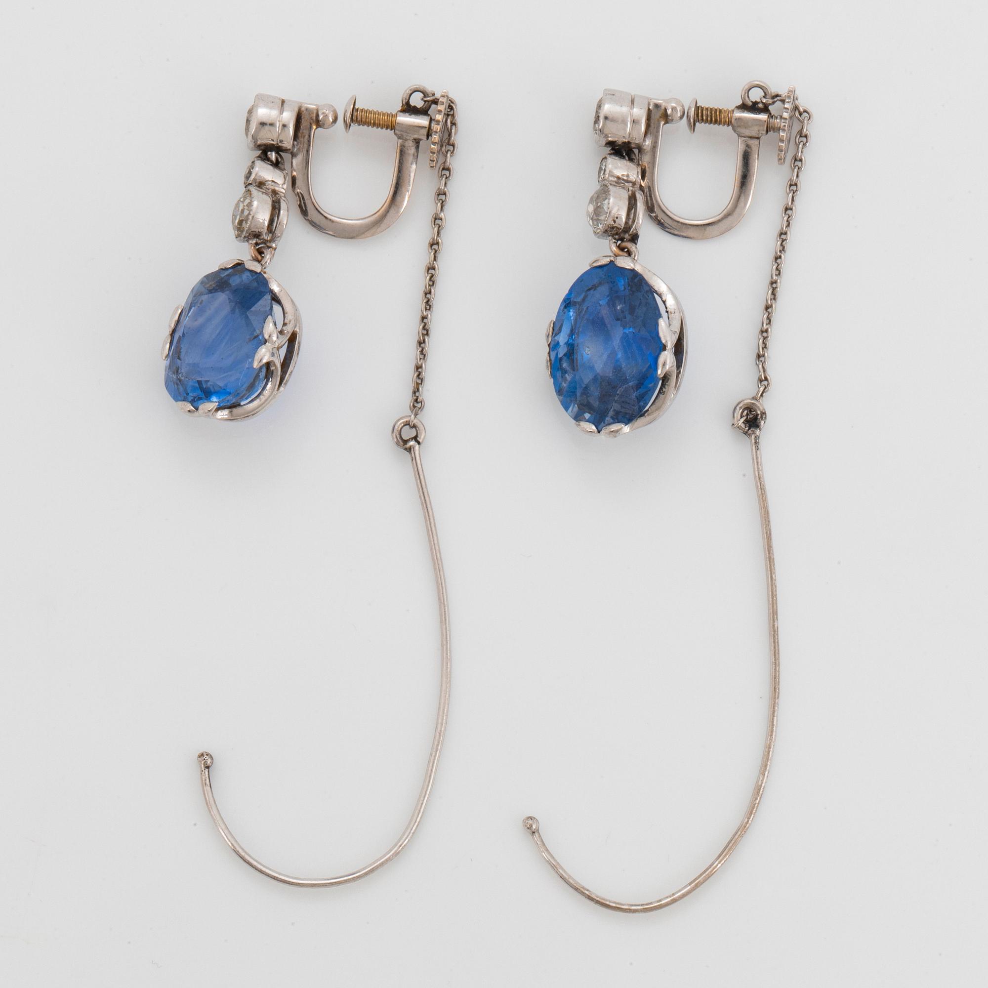 A pair of 18K white gold earrings set with faceted sapphires and old-cut diamonds.