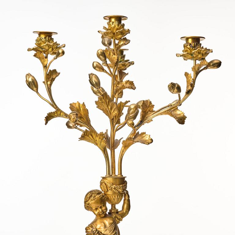 A pair of Louis XVI four light candelabra.