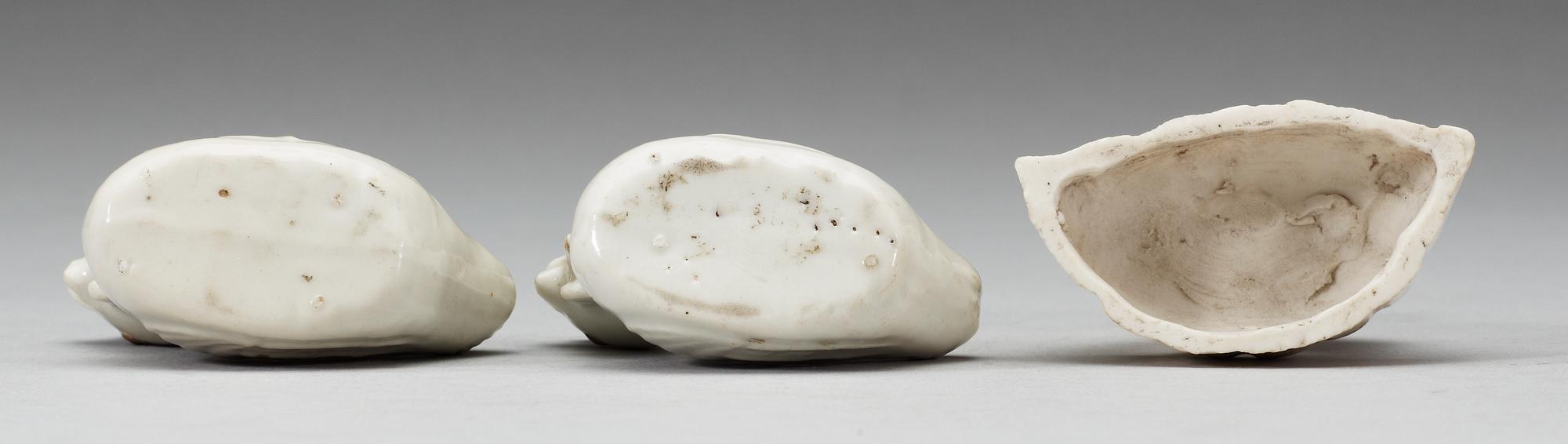 A pair of blanc de chine water droppers and a figure of a 'Buddhist Lion', Qing dynasty, Kangxi (1662-1722).