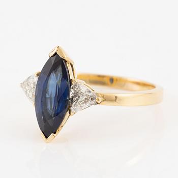 Ring, 18K gold with navette-shaped sapphire and triangle-cut diamonds.