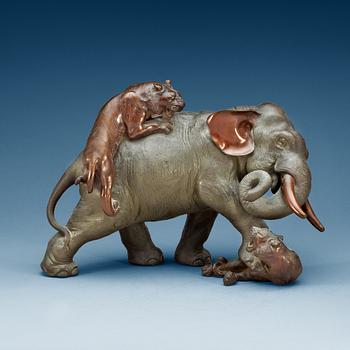 1884. A large Japanese bronze sculpture of an elephant attacked by tigers, with seal mark, Meiji, circa 1900.