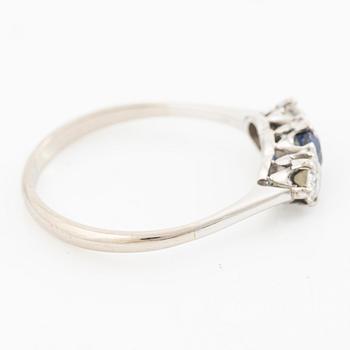 18K gold ring with two old-cut diamonds and a blue stone.
