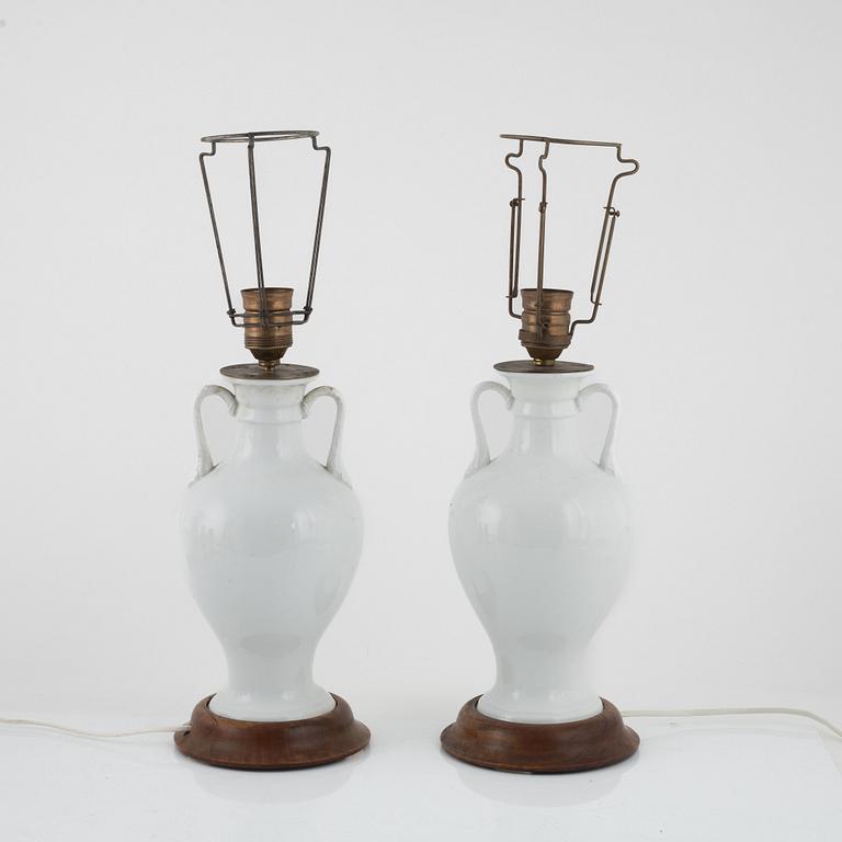 A pair of white porcelain table lamps / urns, Europe 20th century.