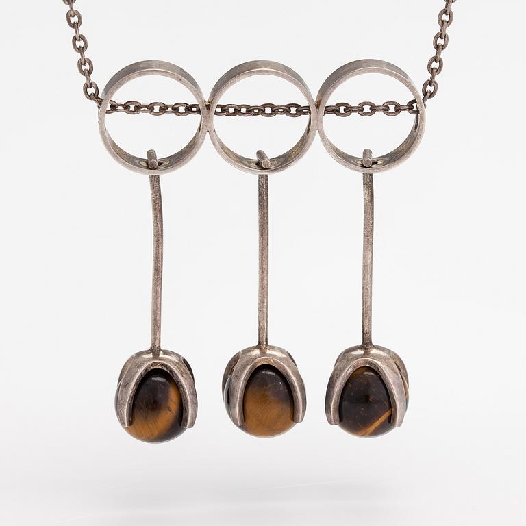 Elis Kauppi, A silver necklace with tiger's eye pearls. Kupittaan kulta, Turku 1965.