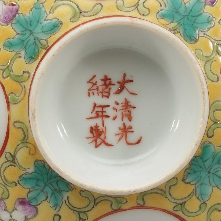 A set of four yellow ground famille rose bowls with covers, early 20th century with Guangxu six character mark in red.