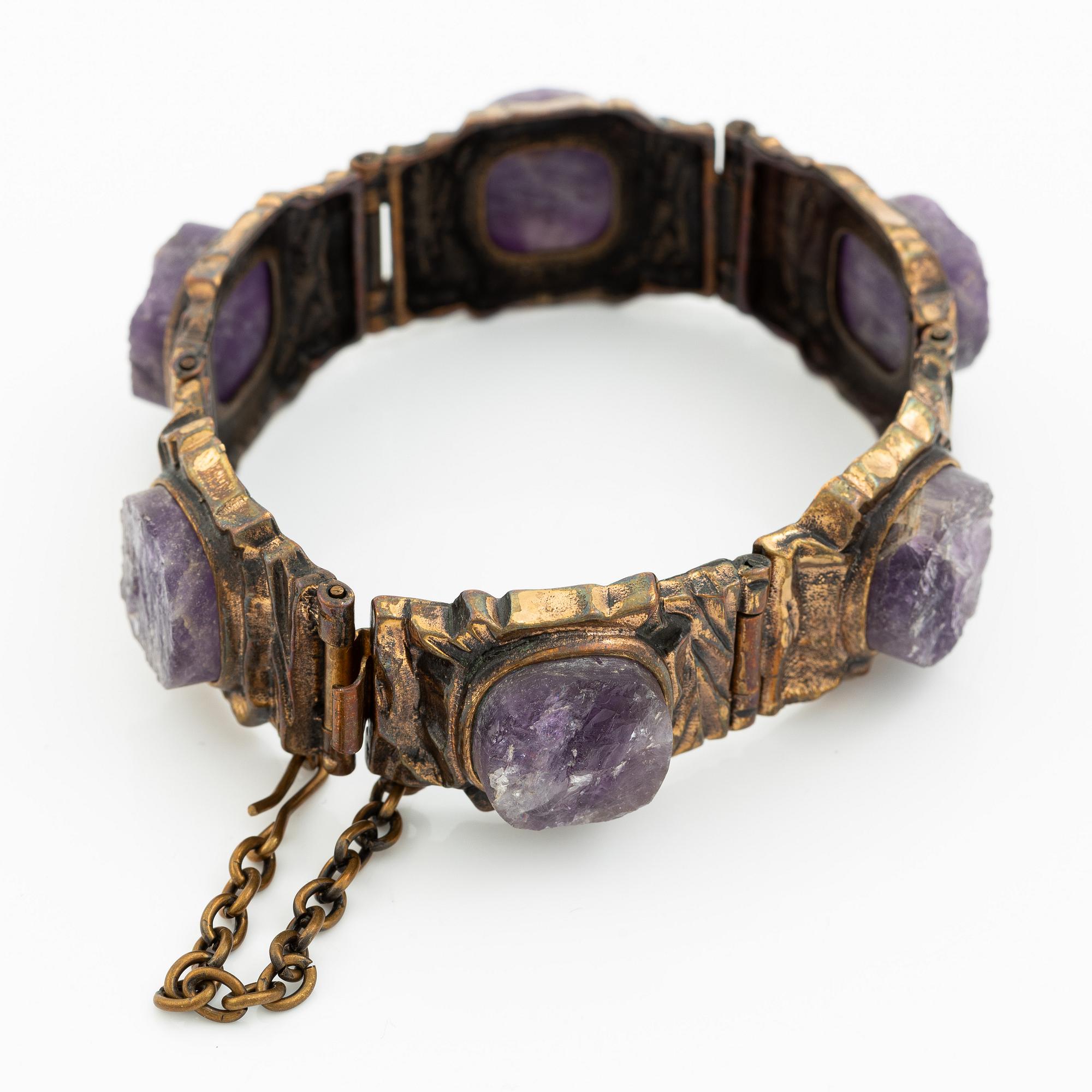 Pentti Sarpaneva, A bracelet, a pair of earrings, a ring, and a pendant, bronze with amethyst, Finland 1960s.
