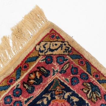 An carpet, possibly Kirman, signed, 350 x 255 cm.