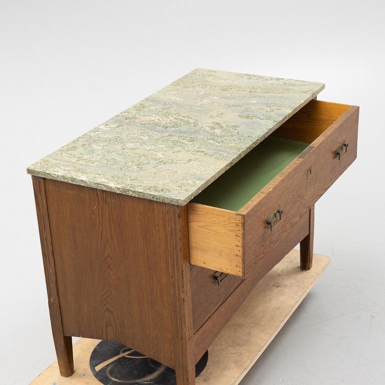 An oak and stone top chest of drawers, 1910's.